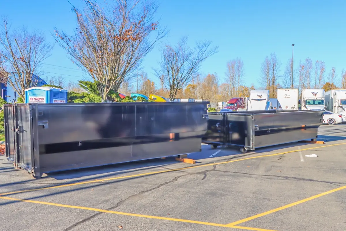 Professional dumpster rental service with roll-off container on residential driveway in Maryland Heights